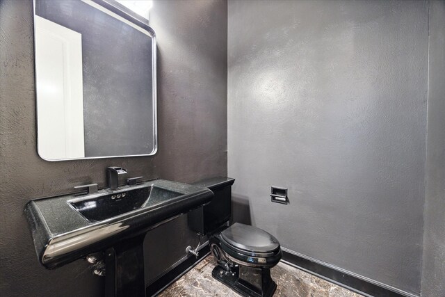 bathroom featuring tile patterned flooring and toilet