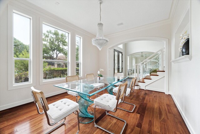 dining room featuring a notable chandelier, dark wood-type flooring, and crown molding