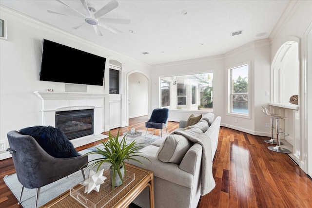 living room featuring crown molding, dark hardwood / wood-style flooring, and ceiling fan