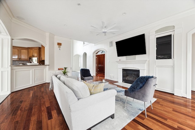 living room featuring ceiling fan, hardwood / wood-style flooring, and crown molding