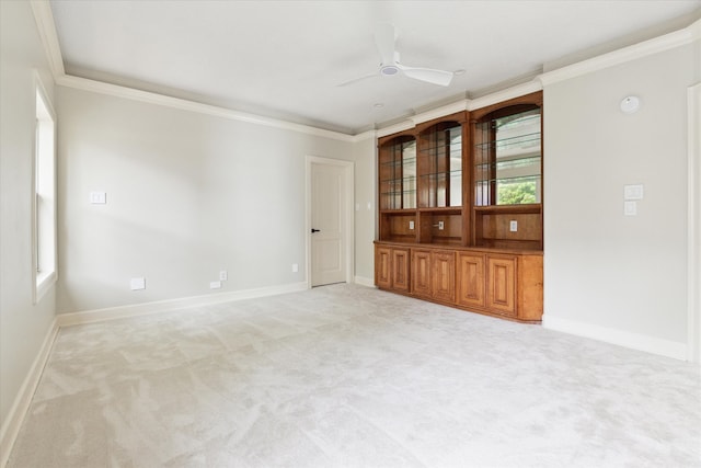 carpeted empty room with ornamental molding and ceiling fan