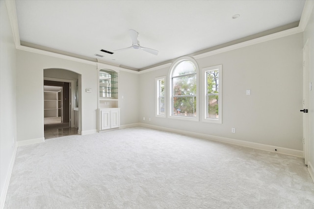 unfurnished room with ceiling fan, ornamental molding, and light carpet