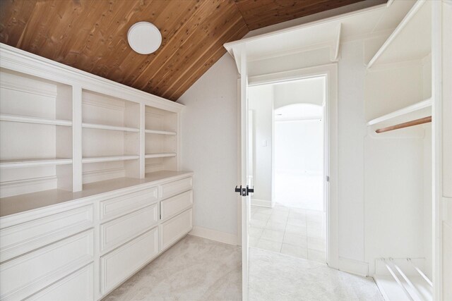 spacious closet with light carpet and vaulted ceiling