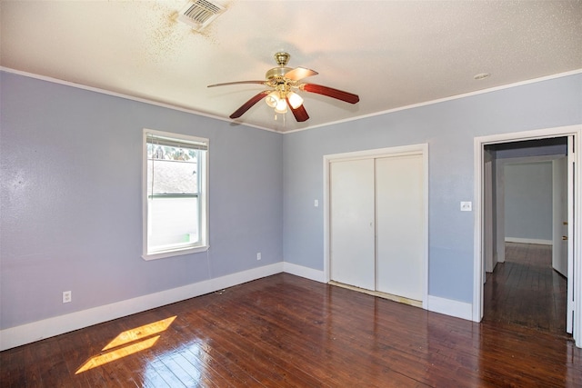 unfurnished bedroom featuring a textured ceiling, crown molding, hardwood / wood-style flooring, a closet, and ceiling fan