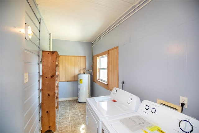 laundry room featuring light tile patterned floors, electric water heater, and washing machine and dryer