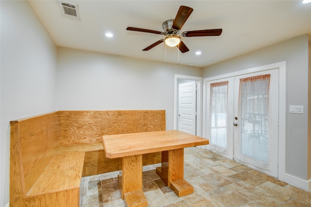 unfurnished dining area with ceiling fan and french doors