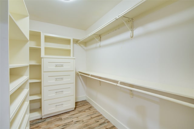 walk in closet featuring light hardwood / wood-style flooring