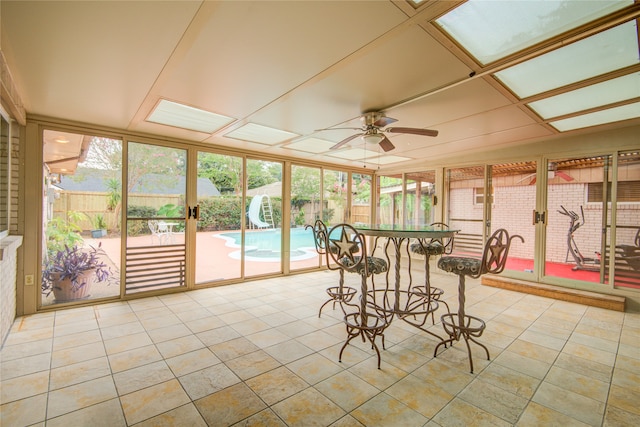 sunroom / solarium with a wealth of natural light and ceiling fan