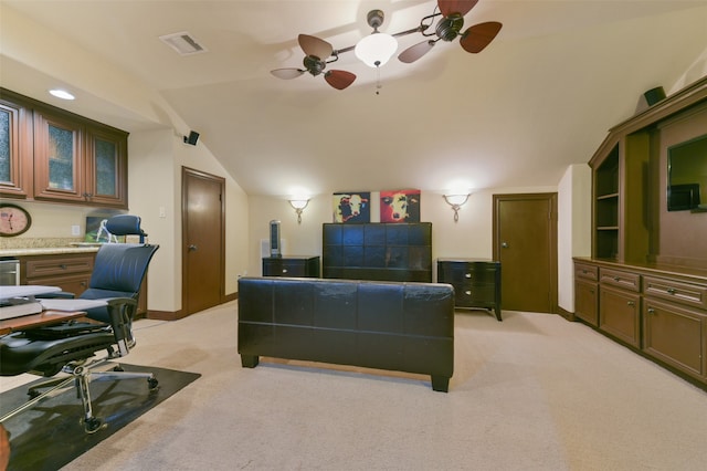 bedroom with ceiling fan, light colored carpet, and vaulted ceiling