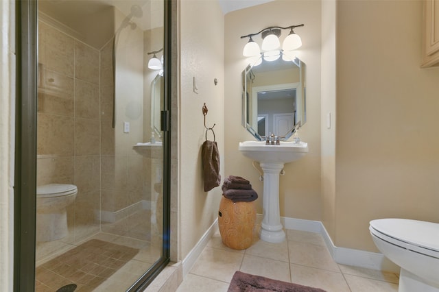 bathroom featuring tile patterned floors, a shower with door, and toilet