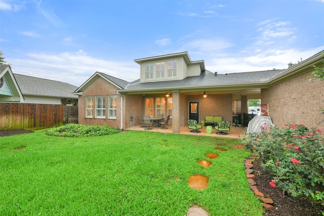 rear view of house featuring a yard and a patio area