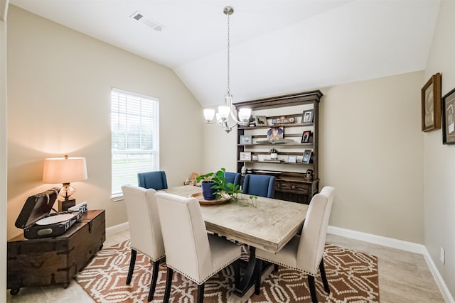 dining room featuring lofted ceiling, light hardwood / wood-style flooring, and a chandelier