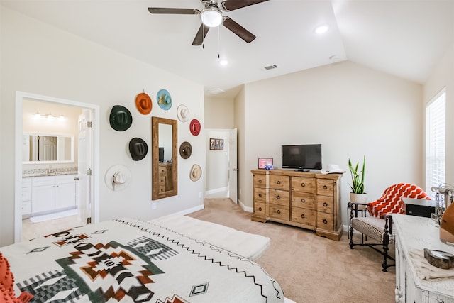 bedroom with connected bathroom, light carpet, lofted ceiling, ceiling fan, and sink