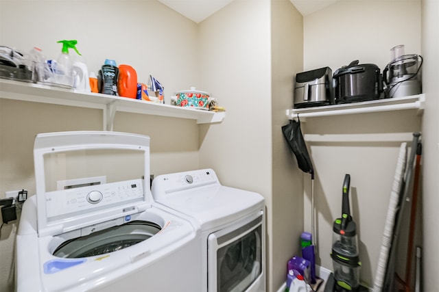 clothes washing area featuring washer and clothes dryer