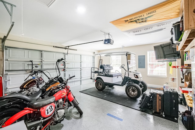 garage with a garage door opener and electric panel