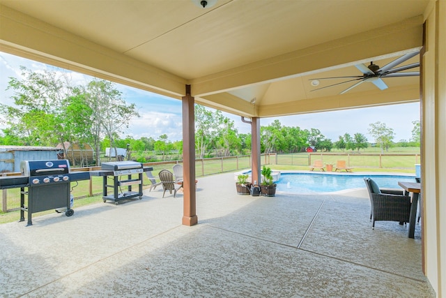 view of patio featuring ceiling fan, a fenced in pool, and a grill