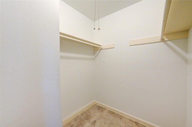 spacious closet with light tile patterned floors