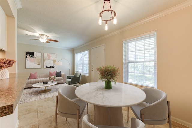 dining area featuring ceiling fan, light tile patterned flooring, and ornamental molding