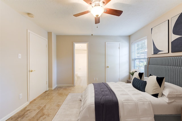 tiled bedroom featuring a textured ceiling, ceiling fan, and ensuite bathroom