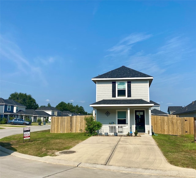 view of front property featuring a front lawn and a porch