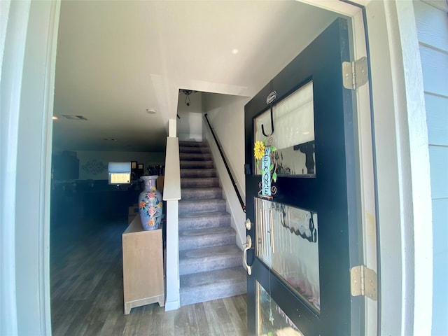 stairway with hardwood / wood-style flooring