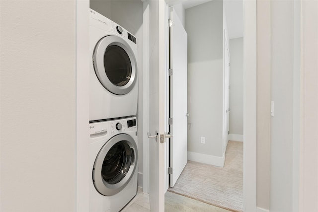 laundry room featuring stacked washer and dryer