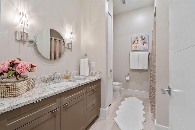 bathroom with tile patterned floors, vanity, and toilet