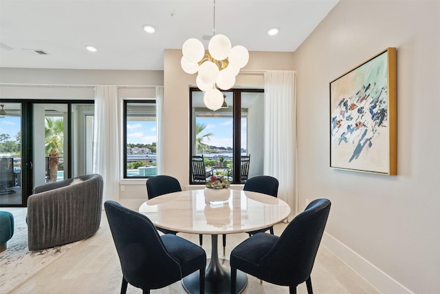 dining space with an inviting chandelier