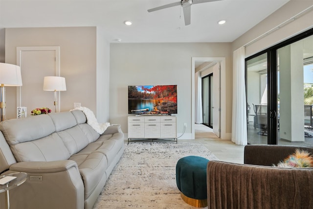 living room with ceiling fan and light hardwood / wood-style floors