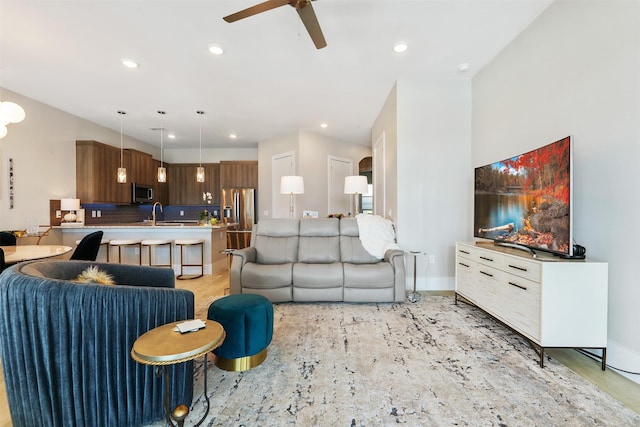 living room featuring ceiling fan and sink