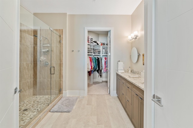 bathroom featuring vanity, hardwood / wood-style floors, and walk in shower