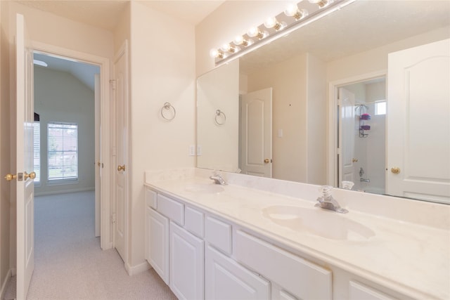 full bathroom with a sink, baseboards, and double vanity