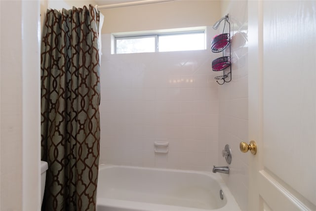 bathroom featuring shower / bath combo with shower curtain