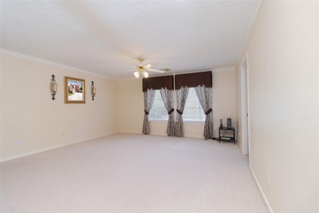 unfurnished room featuring baseboards, ceiling fan, light carpet, and ornamental molding
