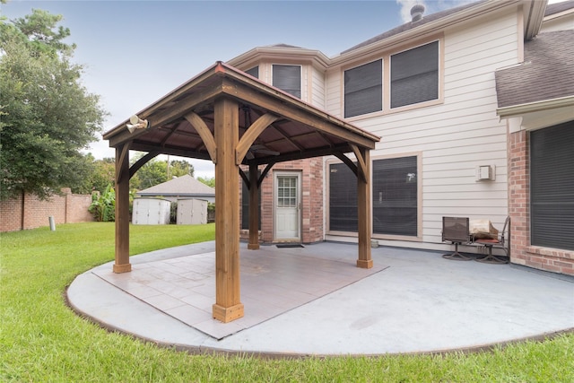 view of patio featuring fence and a gazebo