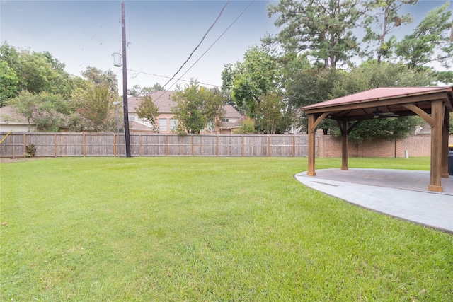 view of yard with a gazebo, a fenced backyard, and a patio area