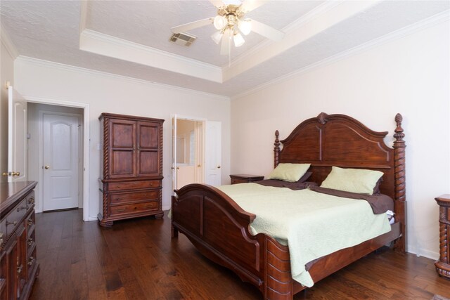 bedroom featuring crown molding, a raised ceiling, visible vents, and dark wood-type flooring