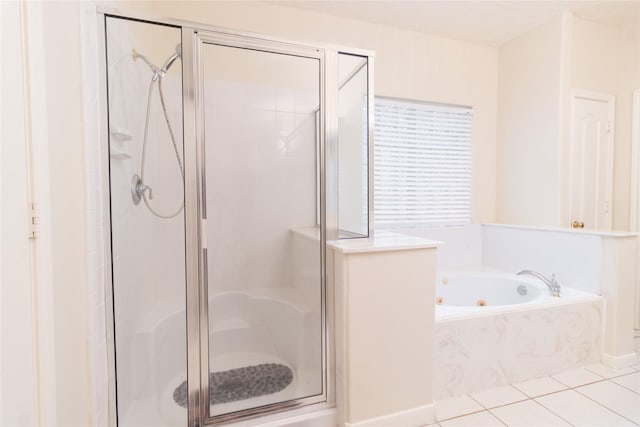 bathroom featuring a whirlpool tub, tile patterned flooring, and a stall shower