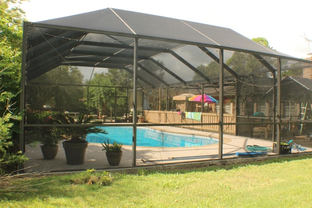 view of swimming pool featuring a lanai