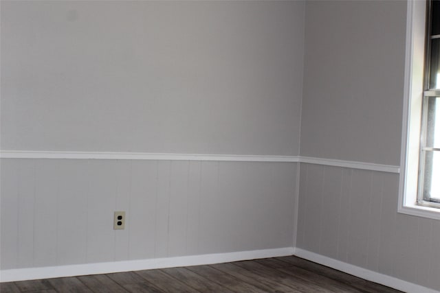 empty room with dark wood-type flooring