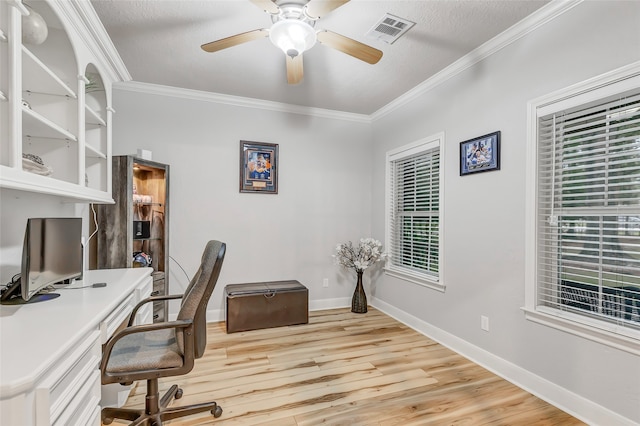 home office featuring ceiling fan, light hardwood / wood-style floors, ornamental molding, and a textured ceiling