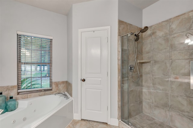 bathroom featuring tile patterned flooring and separate shower and tub