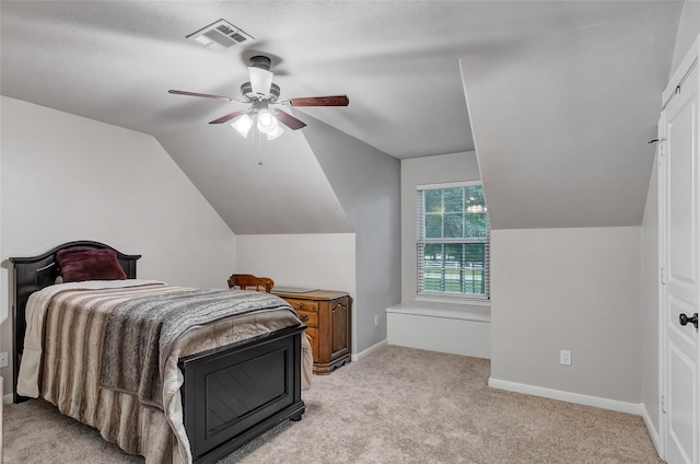 carpeted bedroom featuring ceiling fan and vaulted ceiling