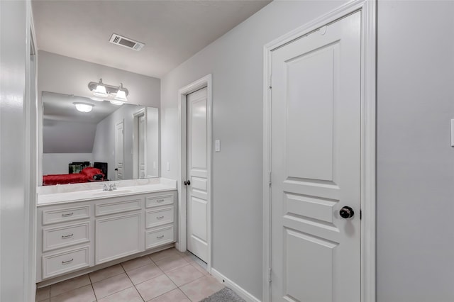 bathroom featuring tile patterned flooring, vanity, and lofted ceiling