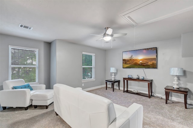 living room with ceiling fan and light colored carpet