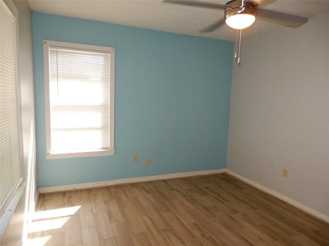 spare room with ceiling fan and hardwood / wood-style flooring