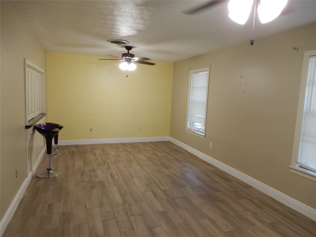 unfurnished room featuring ceiling fan and hardwood / wood-style flooring