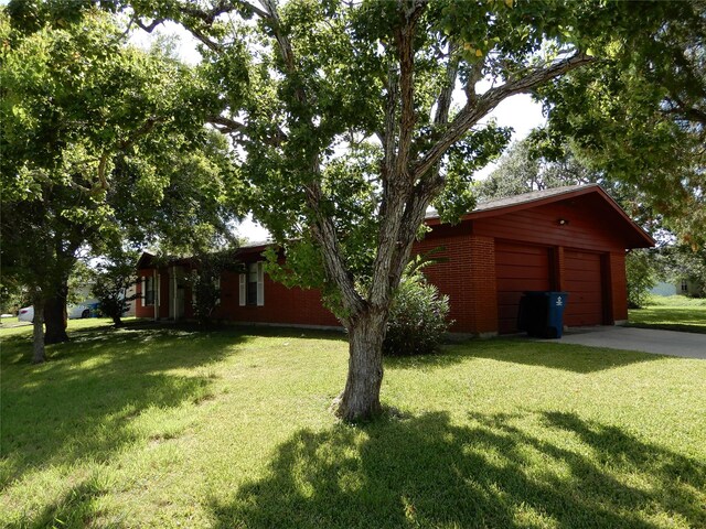 exterior space featuring a yard and a garage