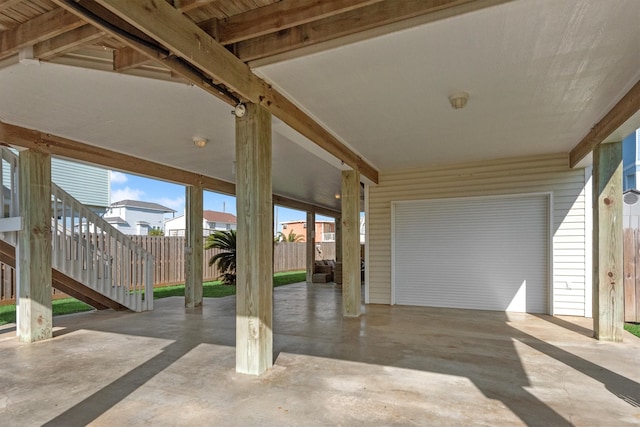 view of patio with stairway and fence