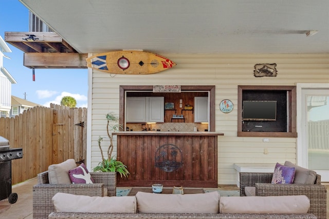 exterior space featuring outdoor lounge area, fence, and area for grilling